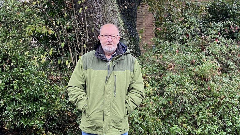 Gary Saunders standing in front of his oak tree