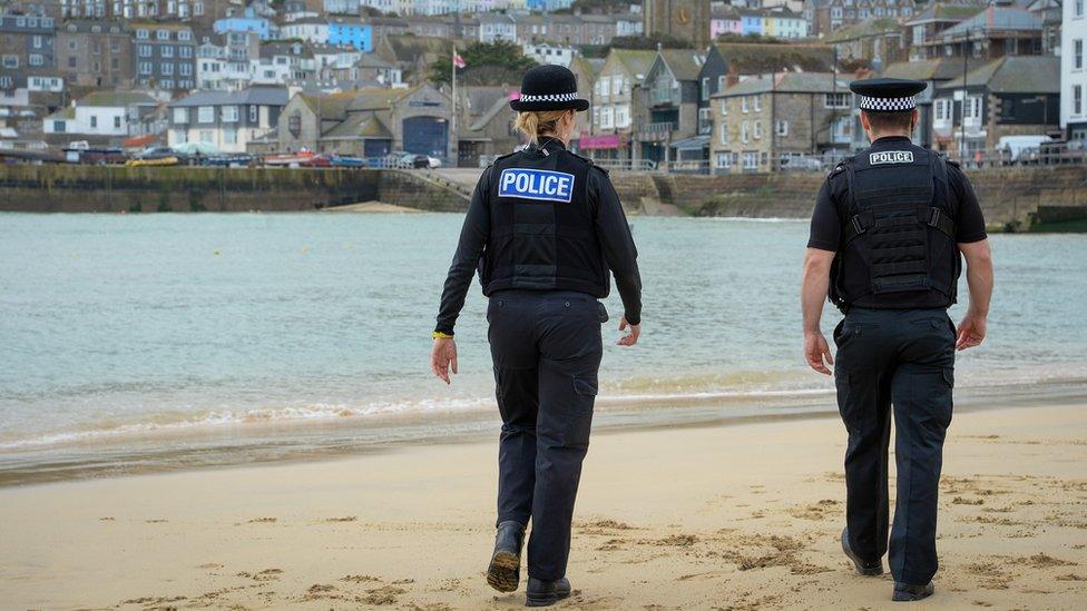 Devon and Cornwall Police officers walking on a beach