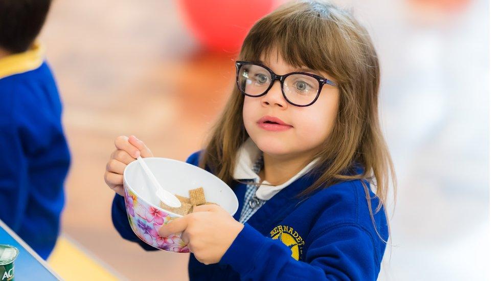 Child with cereal bowl