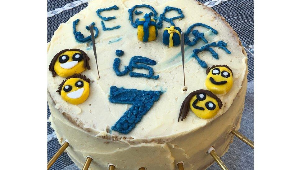 birthday-cake-says-george-in-blue-with-yellow-smiling-faces.