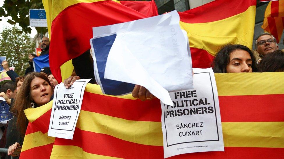 People hold a Catalan flag during a demonstration of pro and anti-Catalans in front of the Press Club in Brussels, on October 31, 2017 during a press conference of the Catalonia"s dismissed leader.