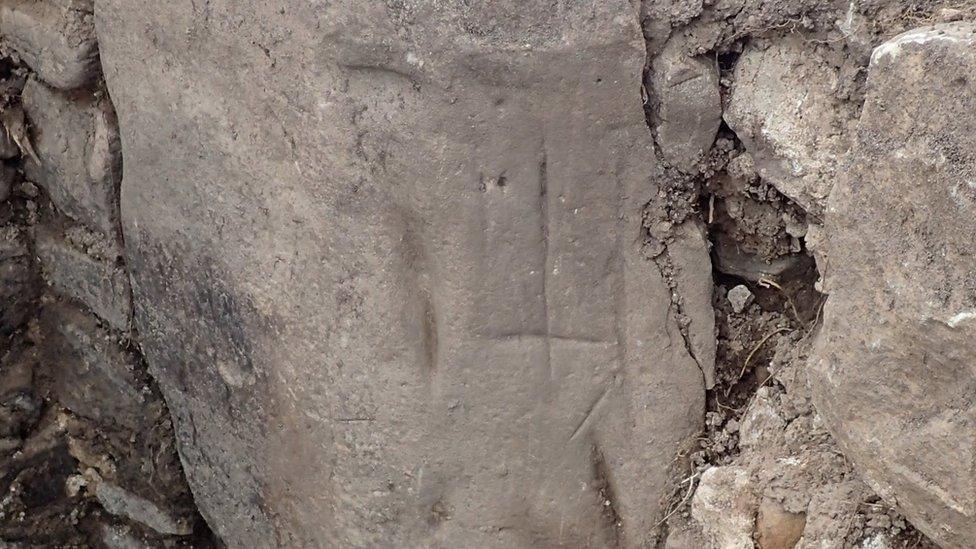 Inverted cross on hearth stone