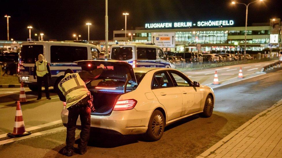 Police check arriving cars outside Schoenefeld Aiport near Berlin following the launch of a manhunt for a terror suspect