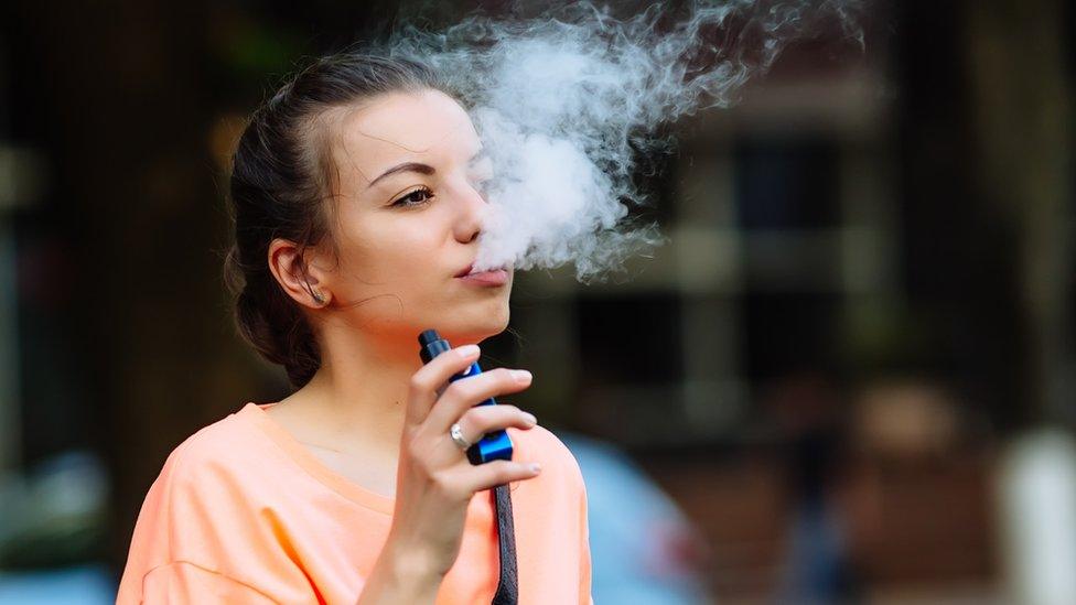 A young woman vaping