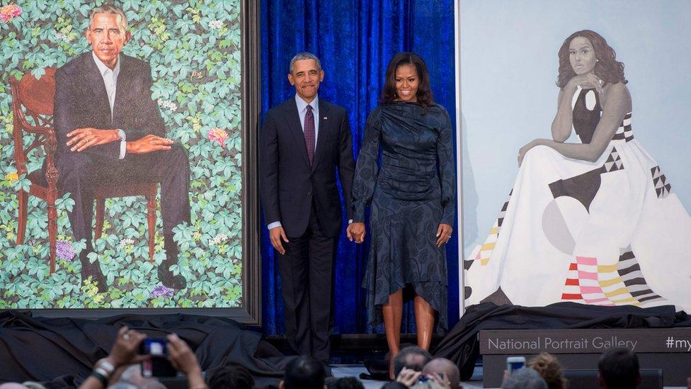 Barack and Michelle Obama stand by their portraits