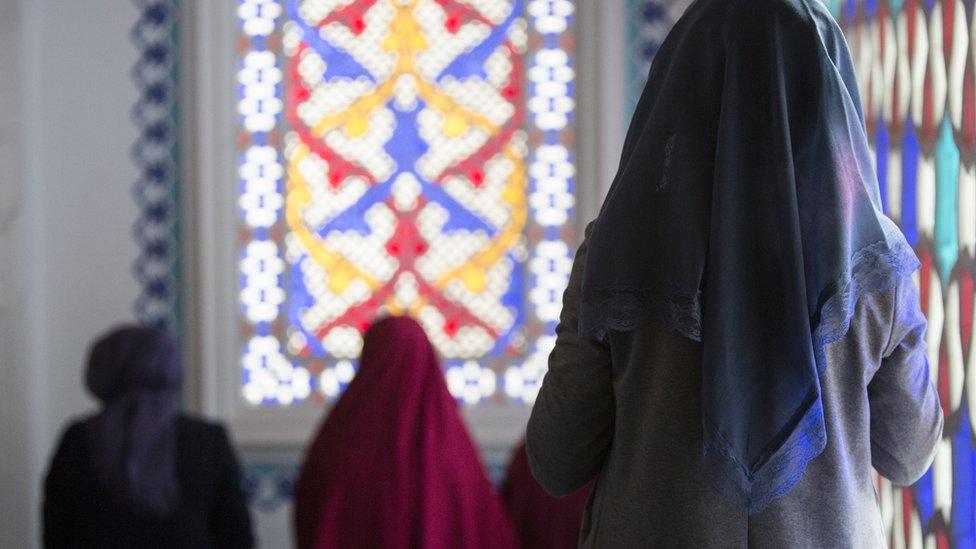 A Muslim woman is seen during midday prayers at a mosque in Berlin