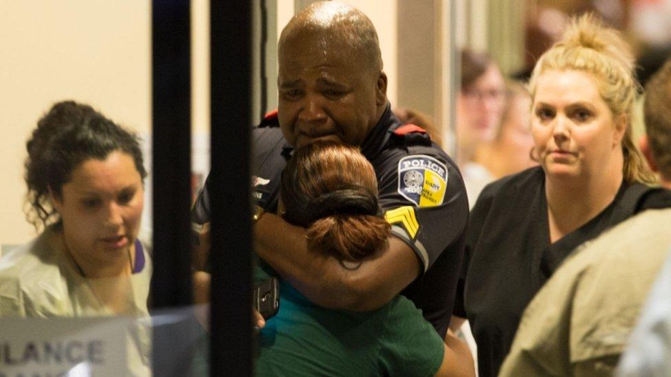 A transport police officer comforts a relative at Baylor University Hospital, 7 July