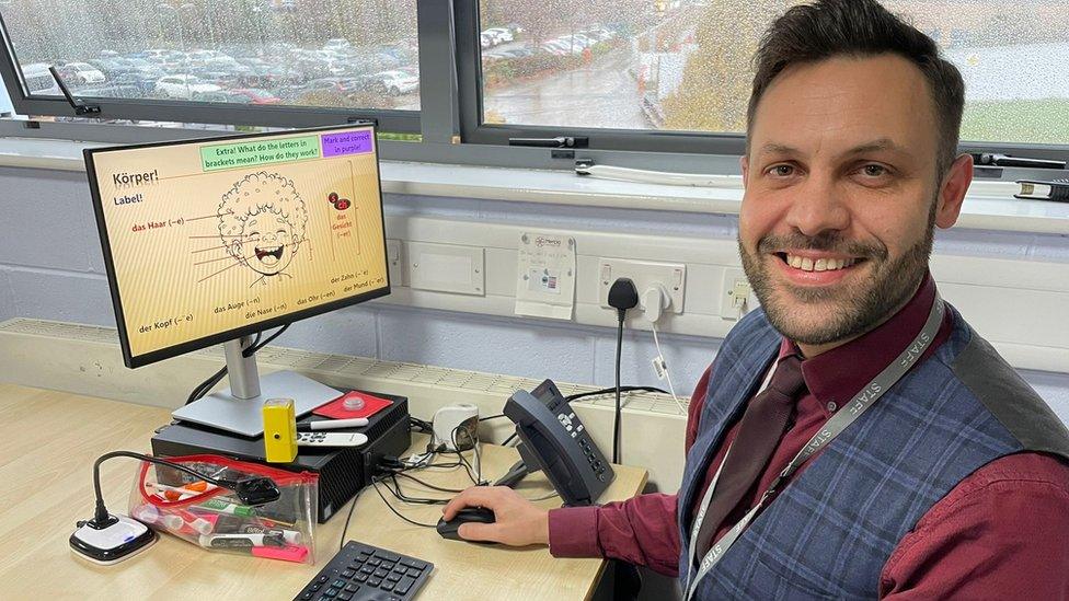 Ben Merritt at a computer in his classroom