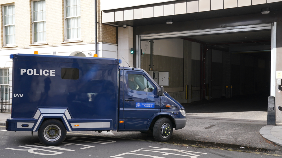 An armoured police van, which arrived with a police escort and is believed to be carrying David Smith