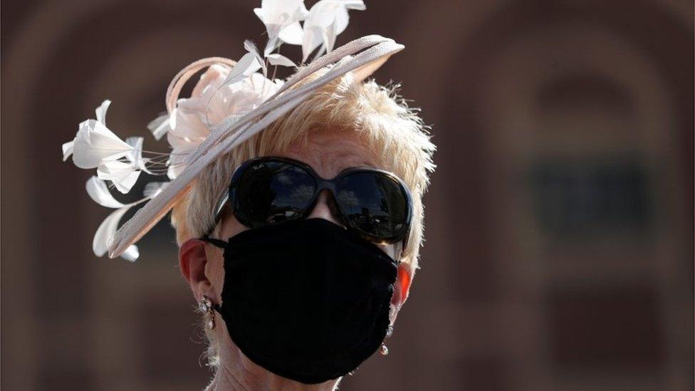 A woman wearing a face mask at Doncaster Racecourse