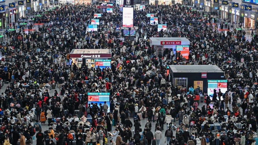 Passengers wait for their train at Hongqiao railway station in Shanghai on January 20, 2023