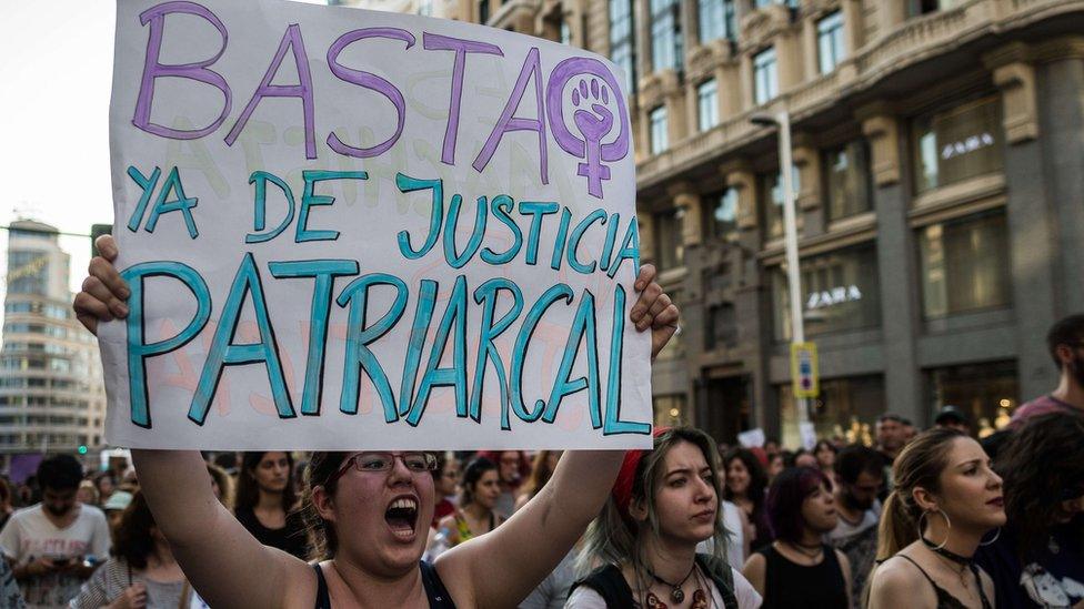 A protester holds a placard that reads "enough of patriarchal justice" during a protest against court's decision to release 'wolf pack' gang on bail. 22 June 2018