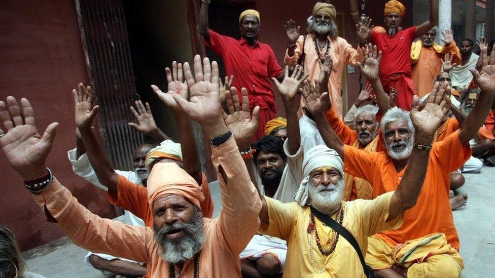 Indian Hindu holy men sit in queue for the registration to the Amarnath shrine pilgrimage.