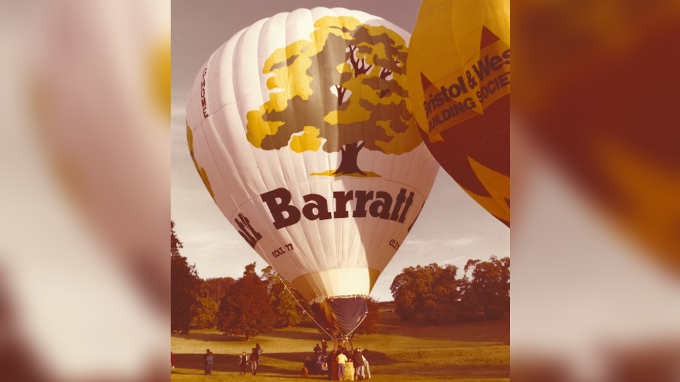 A photo of a balloon with Barratt and a drawing of a tree on the outside