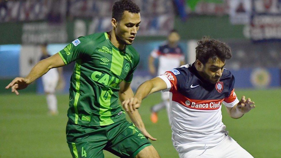 Neto of Brazil's Chapecoense vying for the ball with Ezequiel Cerutti of Argentina's San Lorenzo, during their 2016 Copa Sudamericana semifinal second leg football match on 23 November