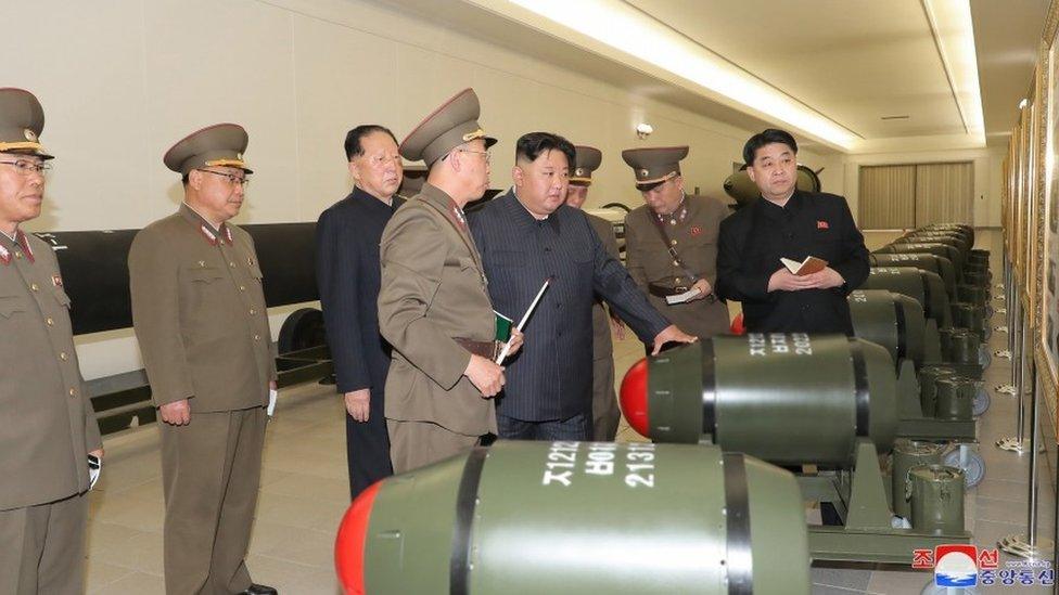 Kim Jong Un with what North Korean state media says are tactical nuclear weapons