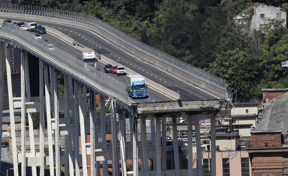 A picture of the Morandi motorway bridge showing the missing area and vehicles close to the edge