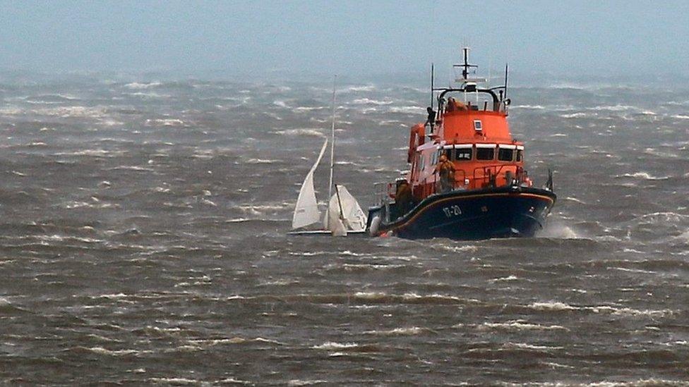 The all weather lifeboat recovering the dinghy
