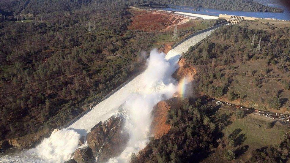 The damaged spillway and the eroded hillside at the Oroville Dam