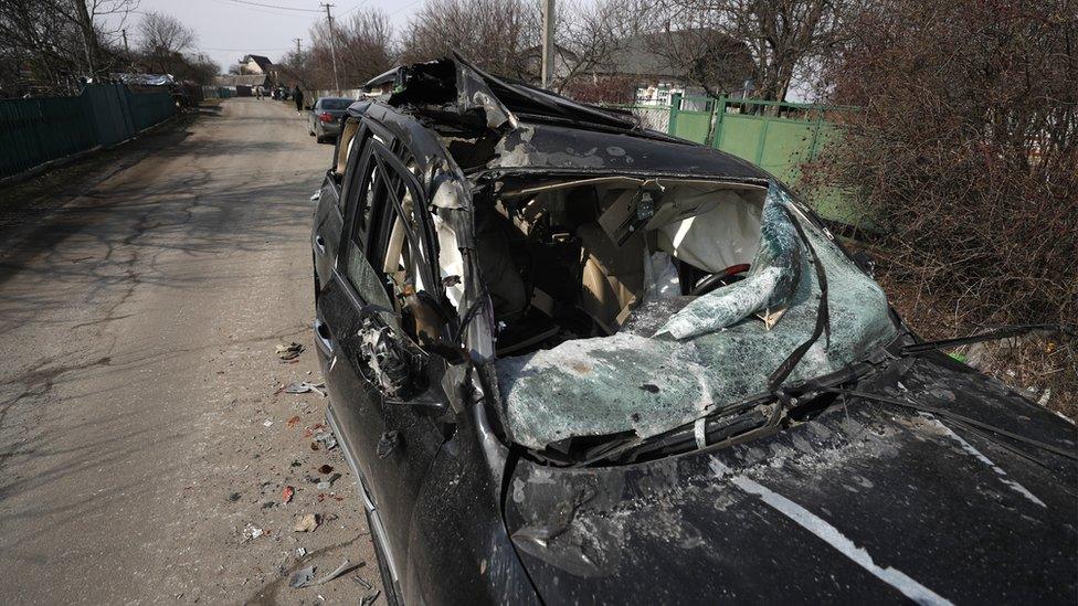 A damaged car is seen at a site of the fighting between Ukrainian and Russian forces on a road leading to the Ukrainian city of Makariv, west of Kyiv,