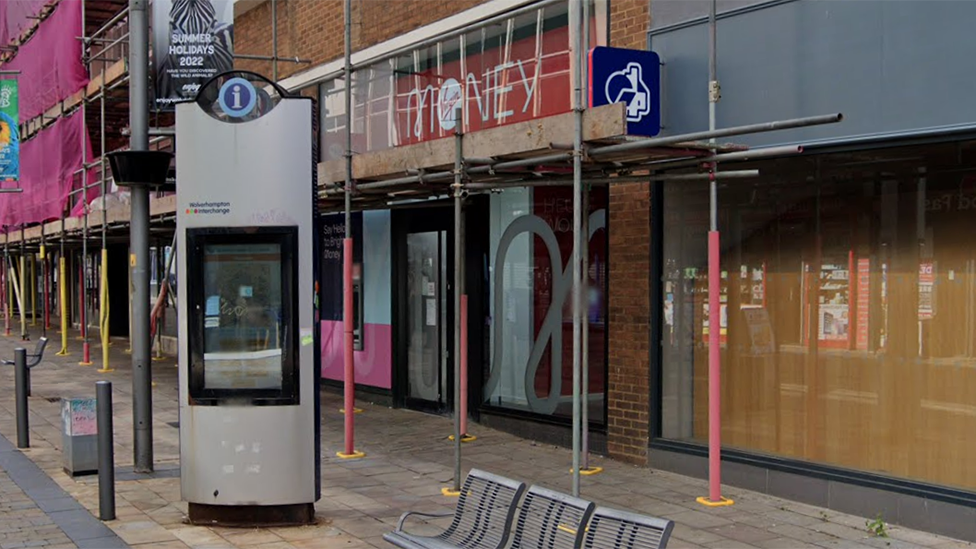 The front of the Virgin Money branch on Queen's Street in Wolverhampton covered with scaffolding. Next door to it is a Nationwide branch