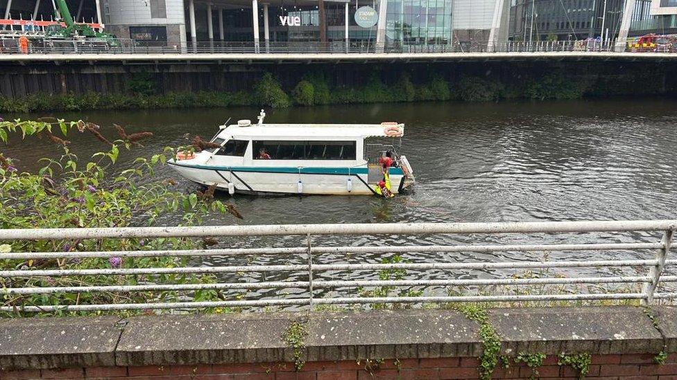 A boat with a fireman in the water