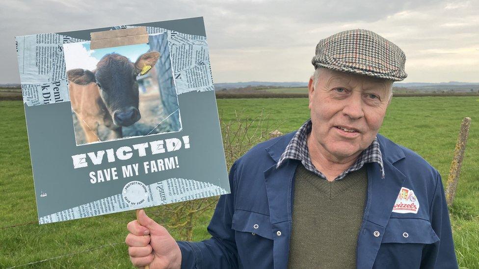 Andrew Dakin with sign