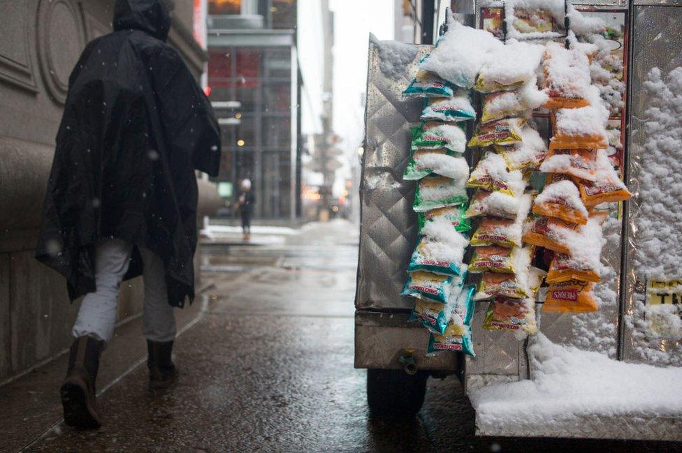 a vendor's crisp bags accumulate wet snow