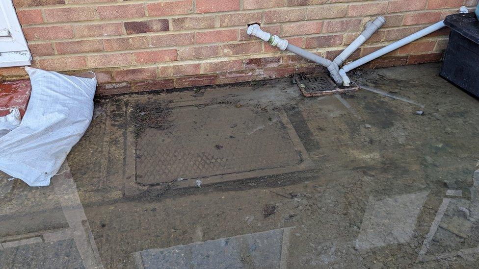 Standing water that has overflowed from a manhole cover