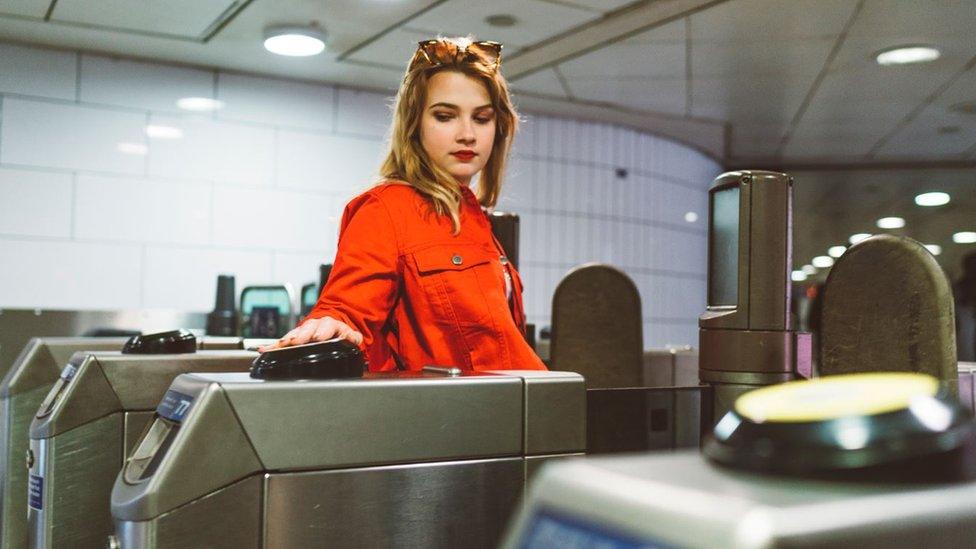 Woman tapping in on tube