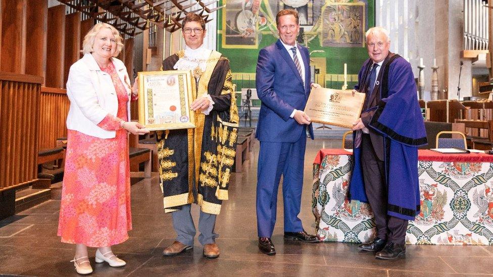 The illuminated minute (left) and plaque (right) given to representatives of the NHS Trust by Coventry's Lord Mayor and Leader of the Council.