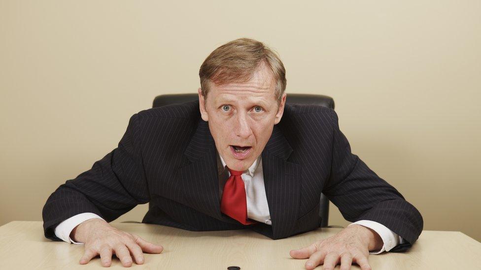 Astonished man at desk