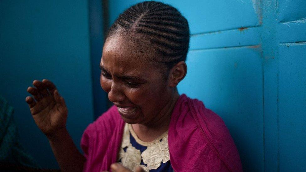 A woman reacts as inhabitants of the mainly Muslim PK5 neighbourhood demonstrate in front of the headquarters of MINUSCA, the UN peacekeeping mission in the Central Africa Republic, in Bangui, on April 11, 2018, where they deposited more than a dozen bodies of the victims of the clashes of April 10.