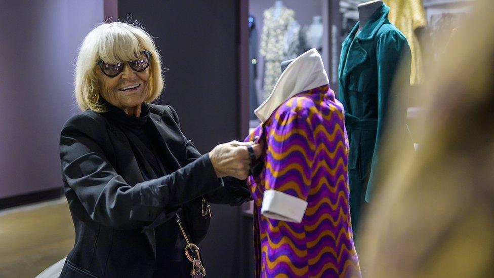 Barbara Hulanicki adjusts clothes on display at the Fashion and Textile Museum