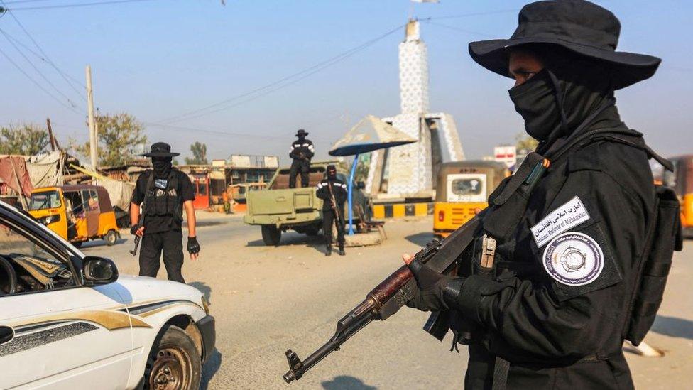 A Taliban guard stands watch