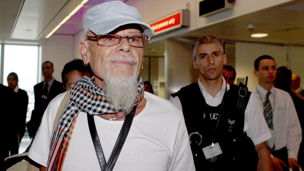 Gary Glitter walking through Heathrow Airport