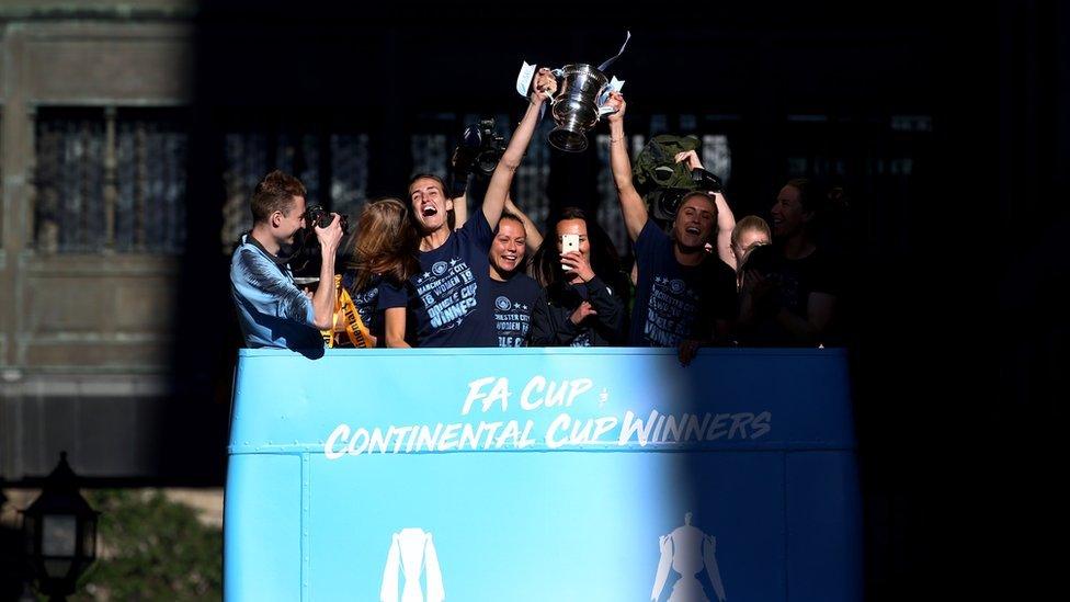 Jill Scott and Steph Houghton of Manchester City lift the SSE Women's FA Cup trophy