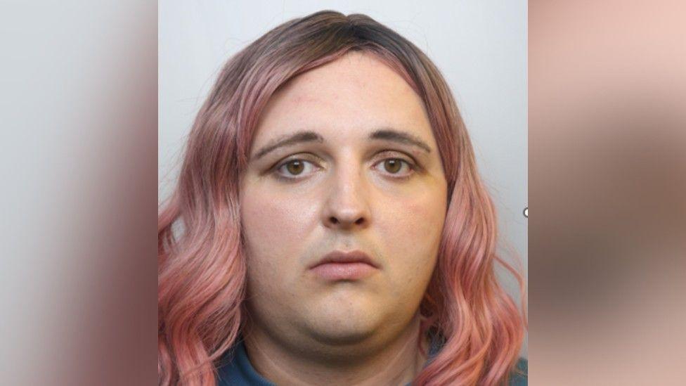 Police image of Bex McCullgh, who has shoulder length pink waved hair