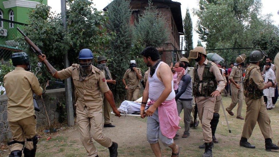 Police and civilians take an injured person away