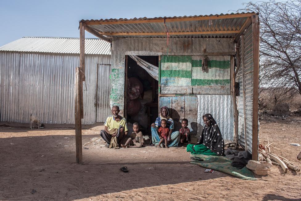 Indhodeeq sits with one of her granddaughters on her lap. Her husband Noor, is blind and her daughter, Hodan, fell ill after recently giving birth.