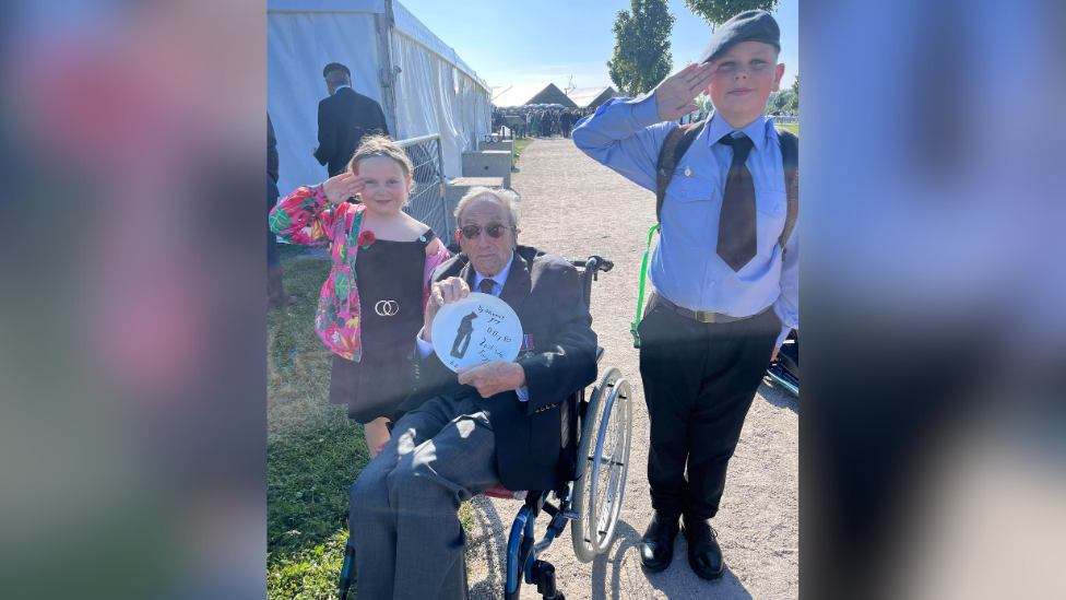 Ellie Mae and Toby with a veteran, who is holding a plate they made