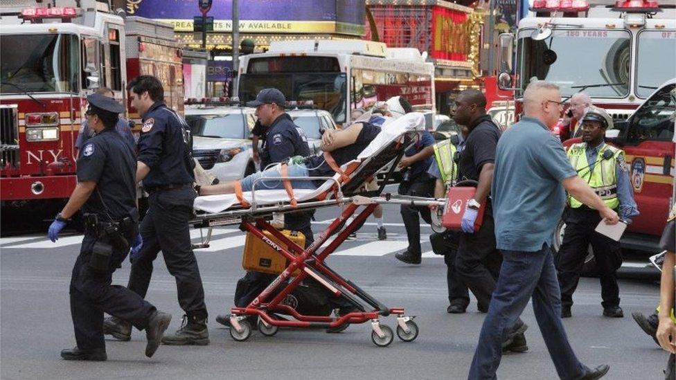 Emergency workers at the scene of the Times Square crash in New York.