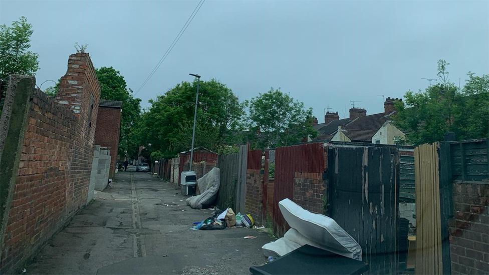 Mattresses in alleyway