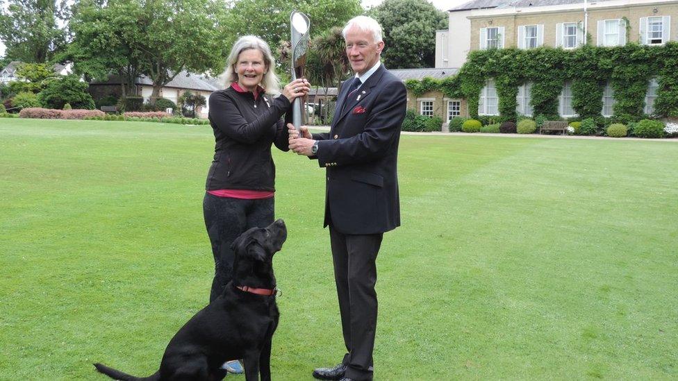 baton with man woman and dog