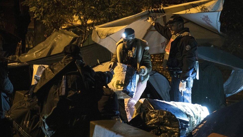 Police inspect tents during a police operation to clear makeshift camps in the north of Paris on 7 November 2019