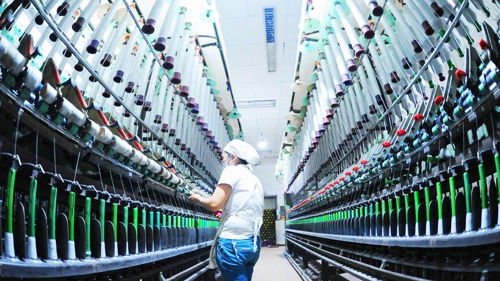 An employee works at a production line of a textile mill in Haizhou District on July 10, 2018 in Lianyungang, Jiangsu Province of China.