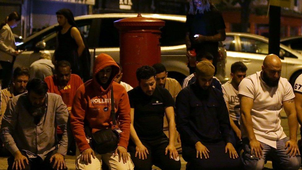 People praying on the street in Finsbury Park