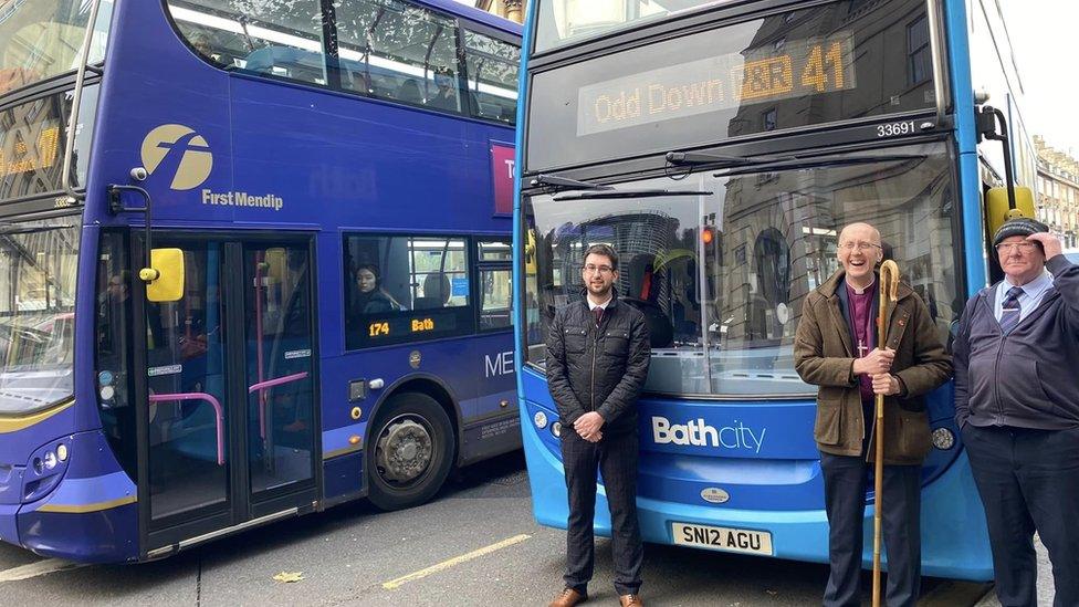 Bishop Michael in front of a bus