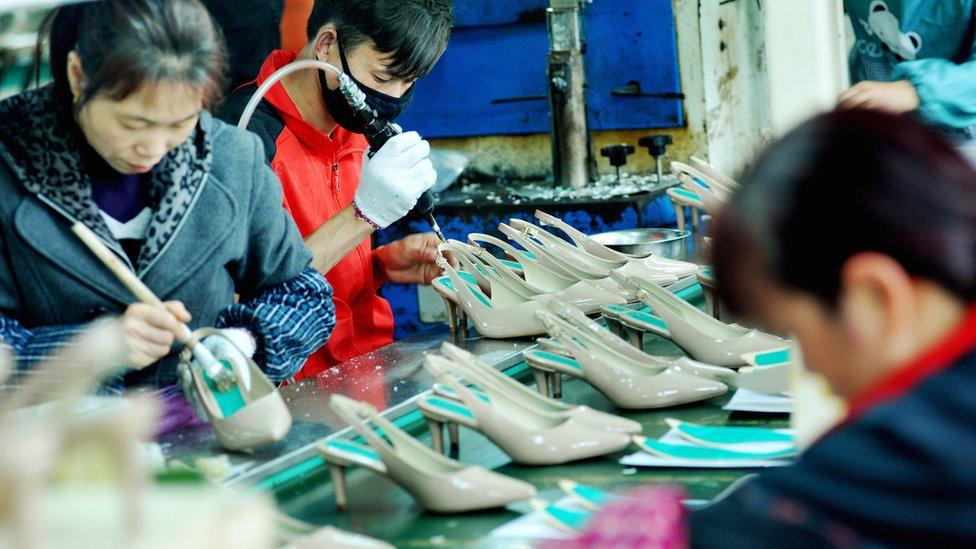 This photo taken on March 25, 2018 shows Chinese employees producing shoes for export at a factory in Shangrao, in China's central Jiangxi province.