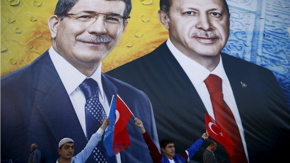 Supporters of the ruling AK Party hold national and party flags as they stand in front of a banner showing Turkish President Tayyip Erdogan and Prime Minister and AK Party Leader Ahmet Davutoglu (L) together during an election rally in central Anatolian city of Konya, Turkey, Friday 30 October 2015